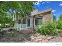 Exterior shot of home with brick accents and landscaped yard at 988 Cleveland Ct, Louisville, CO 80027