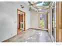 Bright sun room featuring a skylight, neutral tile floors, and natural light at 988 Cleveland Ct, Louisville, CO 80027