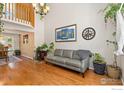 Bright living room with hardwood floors, vaulted ceilings, and stylish decor at 1026 Red Oak Dr, Longmont, CO 80504