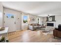 Bright living room with modern furnishings, fireplace, and ample natural light at 10430 Owens Cir, Broomfield, CO 80021