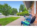 Relaxing front porch with comfortable seating and a view of the landscaped yard at 1085 Jade St, Broomfield, CO 80020