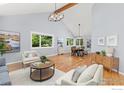 Bright living room featuring vaulted ceilings, exposed beam, and large windows at 1117 Barberry Ct, Boulder, CO 80305