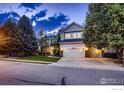 Attractive two-story home with lush front yard and mature shade trees at 1405 Clover Creek Dr, Longmont, CO 80503