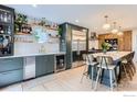 Beautiful kitchen with stainless steel refrigerator, wine cooler, and bar seating at 1405 Clover Creek Dr, Longmont, CO 80503