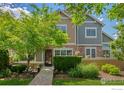 A front exterior home view displaying the garden and landscape, with the house number showing at 14300 Waterside Ln # E3, Broomfield, CO 80023