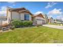 Ranch style home with a well maintained lawn and landscaping, located in a quiet neighborhood at 1613 Alpine Ave, Berthoud, CO 80513