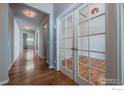 Elegant hallway with hardwood floors, leading to various rooms in the home at 1873 Trevor Cir, Longmont, CO 80501