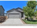 Charming single-Gathering home featuring a two-car garage, a well-maintained lawn and mature landscaping at 2065 Wildwood St, Lochbuie, CO 80603