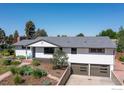 Ranch-style home with two-car garage, landscaped front yard, and inviting entrance at 2125 Rangeview Ln, Longmont, CO 80501