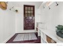 Entryway features a wooden door, white walls, a bench, and stylish decor at 222 Vivian St, Longmont, CO 80501