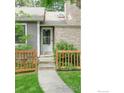 Home front door is set up a short walkway with decorative fencing and freshly mowed lawn at 2325 N Shore Dr, Longmont, CO 80503