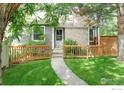Exterior of home featuring brick facade, fresh green lawn and inviting walkway at 2325 N Shore Dr, Longmont, CO 80503