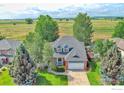 Expansive aerial view of home showcasing its landscaped lot, mature trees, and neighborhood surroundings at 2408 Eagleview Cir, Longmont, CO 80504