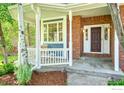 Close up of the charming covered front porch with white railing and a view of the front door at 2408 Eagleview Cir, Longmont, CO 80504