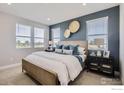Comfortable bedroom with large windows, wood frame bed, and modern decor at 2763 Bear Springs Cir, Longmont, CO 80503
