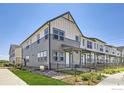 Modern home exterior with gray siding, a black fence, and green grass at 2763 Bear Springs Cir, Longmont, CO 80503