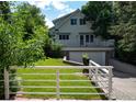 Back of house with a second story deck, white fence and green yard at 2949 10Th St, Boulder, CO 80304