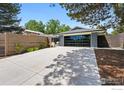 Modern driveway with large, sleek garage door complemented by a well-maintained yard and wooden fence at 3275 19Th St, Boulder, CO 80304