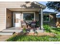 Inviting front porch with comfortable seating, perfect for relaxing outdoors at 4240 Harlan St, Wheat Ridge, CO 80033