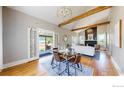 Open dining area with hardwood floors, modern lighting, and access to the living room at 5326 Lowell Blvd, Denver, CO 80221