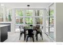 Bright dining area featuring large windows offering picturesque views of the lush backyard at 580 Pleasant St, Boulder, CO 80302