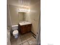 Bathroom with tiled floor, vanity with sink, toilet, and shower/tub combination at 601 5Th St, Frederick, CO 80530