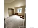 Bright bedroom featuring a closet and window for natural light, with neutral carpeting at 601 5Th St, Frederick, CO 80530