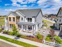 Aerial view of a charming home with a well-manicured yard and inviting outdoor entertainment area at 91 Westerly Blvd, Erie, CO 80516