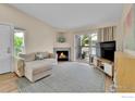 Bright living room with a cozy fireplace, comfortable sofa, and access to the outdoor patio at 1050 Opal St # 203, Broomfield, CO 80020