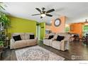 The living room is bright and airy with contemporary furnishings and laminate flooring at 10573 Ashwood St # 334, Firestone, CO 80504