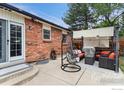 Backyard patio area perfect for outdoor relaxation and entertaining, featuring comfortable seating and a shade structure at 11064 Otis St, Westminster, CO 80020