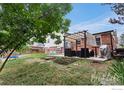 Lush backyard showcasing a patio area, garden beds, and ample green space for outdoor activities at 11064 Otis St, Westminster, CO 80020
