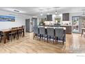 Spacious kitchen with a large center island, modern appliances, and stylish pendant lighting fixtures at 11064 Otis St, Westminster, CO 80020