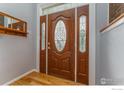 Elegant front door with decorative glass panels, adding a touch of sophistication to the entrance at 13313 W Utah Cir, Lakewood, CO 80228