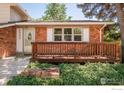 Charming front porch with wood railings and brick accents, creating a welcoming entrance to the home at 1332 S Lincoln St, Longmont, CO 80501