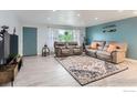 Inviting living room featuring modern flooring, neutral-toned sofas and a stylish area rug at 1345 Northwestern Rd, Longmont, CO 80503