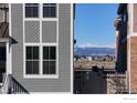Exterior showing windows, gray siding and a mountain view in the distance at 138 Westerly Blvd, Erie, CO 80516