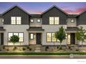 Charming townhome with white siding, dark trim, and low maintenance landscaping at 1776 Glacier Ave, Berthoud, CO 80513