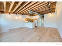 Bright living room with hardwood floors, exposed wood ceiling, and open floor plan into the kitchen at 1941 Pearl St # 303, Boulder, CO 80302