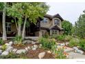 Charming exterior of a two-story home with beautiful landscaping and a stone-lined walkway at 2121 Jade Way, Longmont, CO 80504
