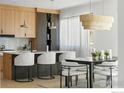 Stylish kitchen boasts sleek cabinets, a central island with seating, and an adjacent dining space with modern decor at 2206 Alpine Dr, Boulder, CO 80304