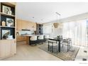 Bright kitchen featuring modern cabinets, an island with seating, and a dining area with stylish light fixture at 2206 Alpine Dr, Boulder, CO 80304