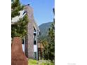 Exterior shot showcasing a stone chimney feature and the home's address at 237 Puma Dr, Boulder, CO 80302