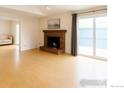 Bright living room with a cozy fireplace and sliding glass doors leading to the outside at 3119 Westwood Ct, Boulder, CO 80304