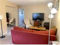 Cozy living room featuring a modern entertainment center and neutral walls at 3161 Madison Ave # 313, Boulder, CO 80303