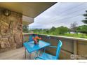 Balcony with outdoor seating and scenic views of trees and blue skies at 3240 Iris Ave # 201, Boulder, CO 80301