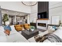 Spacious living room featuring a fireplace, comfortable seating, and contemporary decor at 3315 Heron Lakes Pkwy, Berthoud, CO 80513