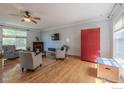 Spacious living room with a fireplace, hardwood floors, and large windows at 3598 Larkspur Dr, Longmont, CO 80503