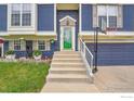Close-up of home's front entrance featuring a green door, and concrete stairs at 360 Wellington Ave, Lafayette, CO 80026