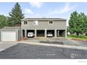 Two-story building featuring open carports underneath, and a small storage shed on the left at 3790 Iris Ave # D, Boulder, CO 80301